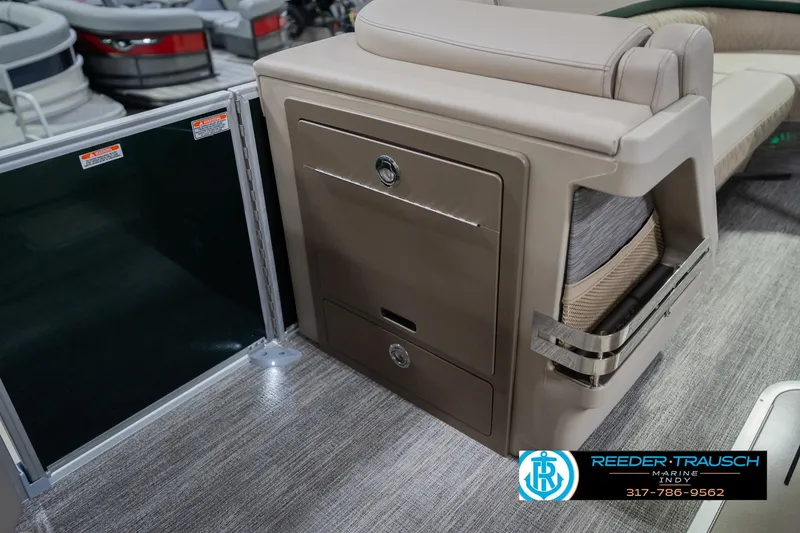 Slide: The Image of 2026 Bennington 24 MFB boat interior with storage compartment and seating. - 25
