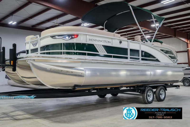 Slide: The Image of 2026 Bennington 24 MFB pontoon boat on trailer in indoor showroom. - 3