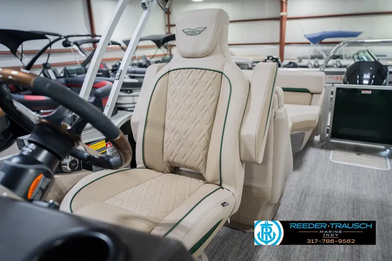 Slide: The Image of 2026 Bennington 24 MFB boat interior with luxurious beige seating and steering wheel. - 39