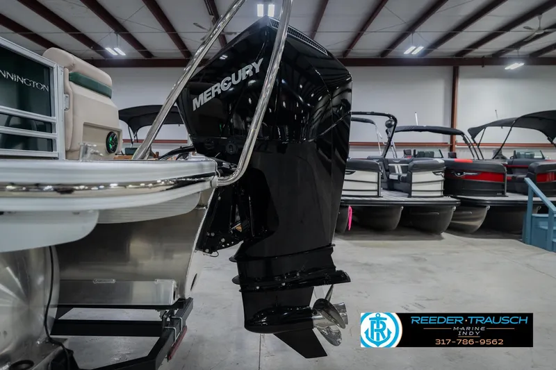 Slide: The Image of 2026 Bennington 24 MFB pontoon boat with Mercury outboard motor in showroom. - 51