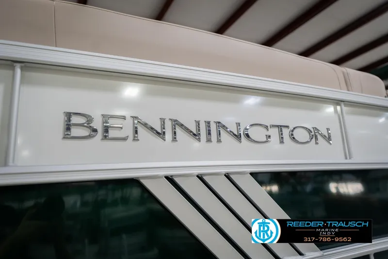 Slide: The Image of 2026 Bennington 24 MFB boat with sleek design and logo detail. - 55