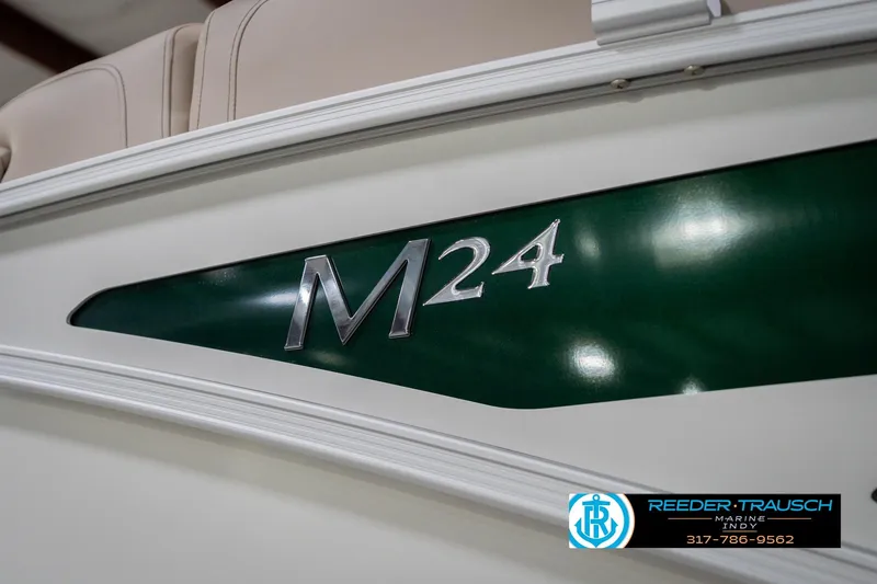 Slide: The Image of 2026 Bennington 24 MFB boat, green and white design, Reeder Trausch Marine logo. - 57