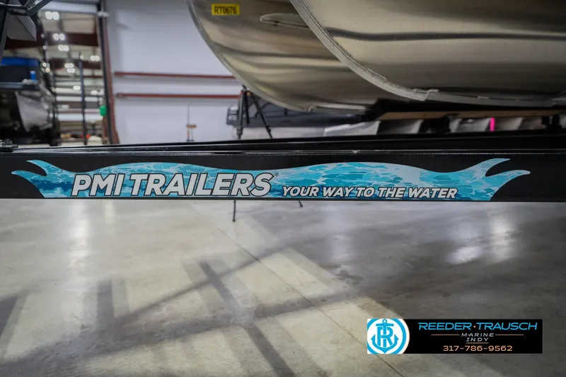 Slide: The Image of Trailer for 2026 Bennington 24 MFB, featuring PMI Trailers branding in a showroom. - 59