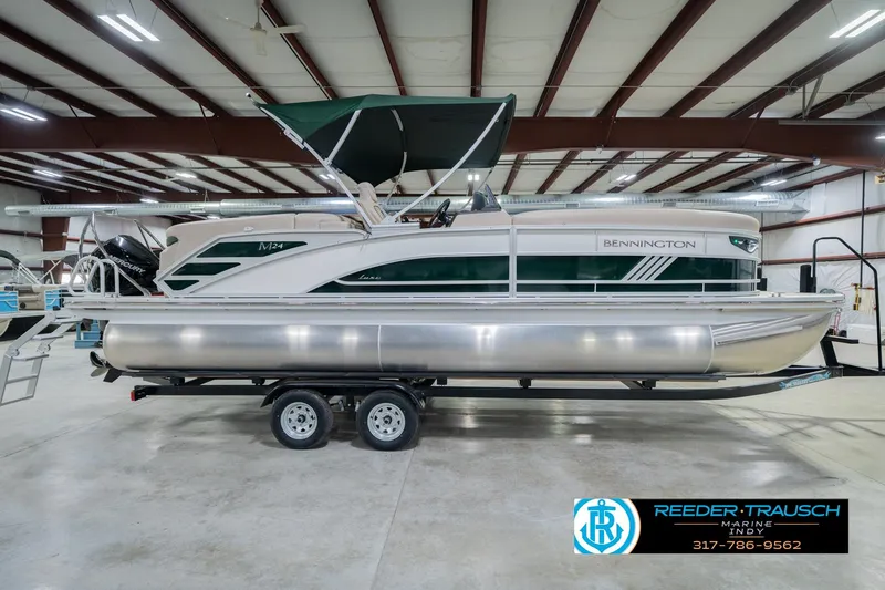 Slide: The Image of 2026 Bennington 24 MFB pontoon boat in a spacious indoor showroom. - 6