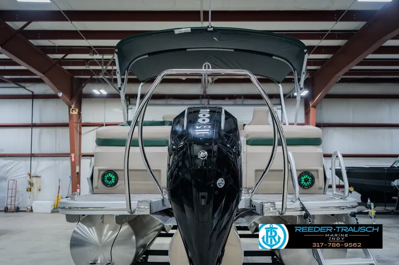 Slide: The Image of 2026 Bennington 24 MFB pontoon boat with powerful outboard motor in a showroom. - 8