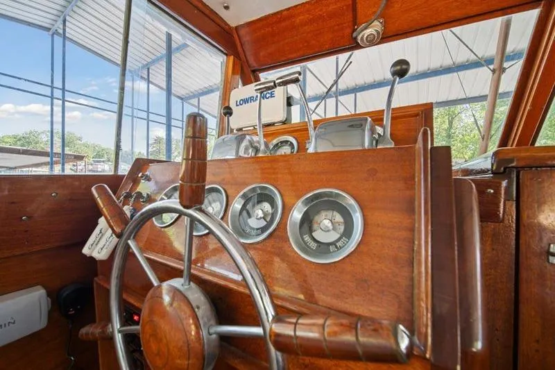 Slide: The Image of 1964 Chris-Craft 37 Constellation helm with wooden steering wheel and vintage gauges. - 11