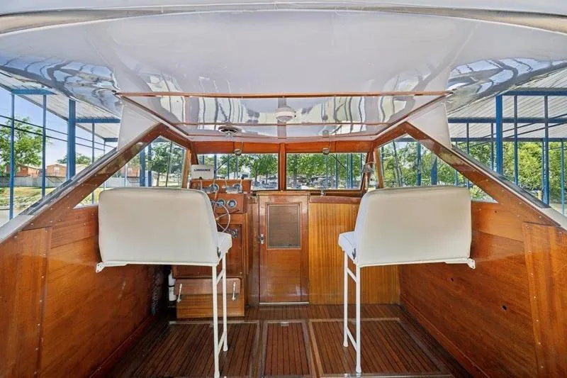 Slide: The Image of 1964 Chris-Craft 37 Constellation boat interior with wooden finish and white seats. - 15
