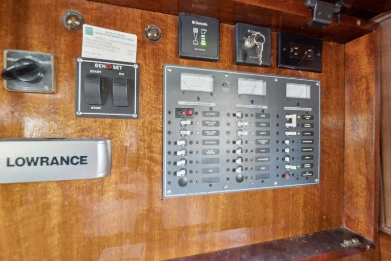 Slide: The Image of Control panel of a 1964 Chris-Craft 37 Constellation boat with switches and gauges. - 16
