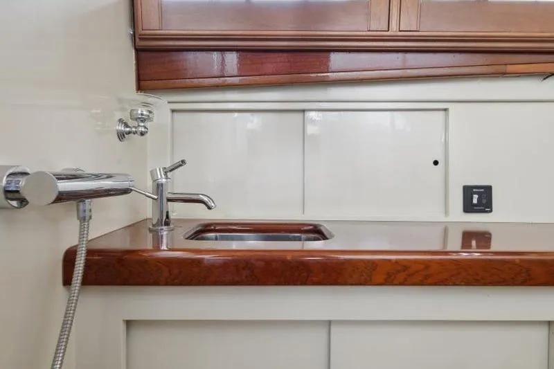 Slide: The Image of 1964 Chris-Craft 37 Constellation yacht interior with wooden countertop and sink. - 20