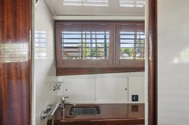 Slide: The Image of 1964 Chris-Craft 37 Constellation interior with wooden cabinetry and sink. - 21