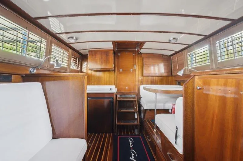 Slide: The Image of 1964 Chris-Craft 37 Constellation interior with wood paneling and white seating. - 24