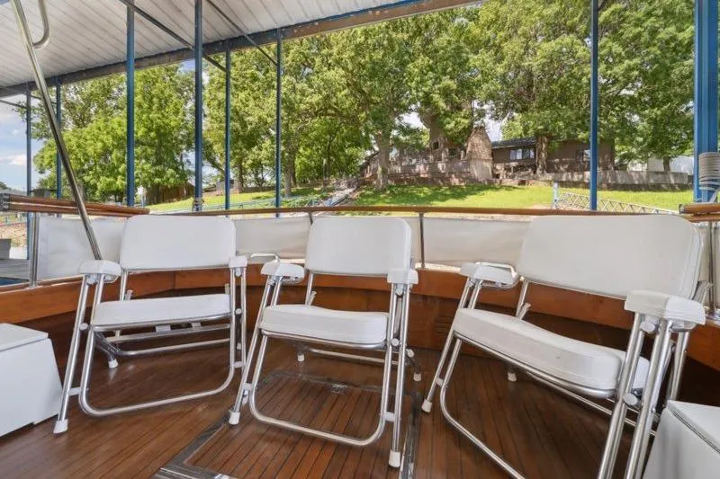 Slide: The Image of 1964 Chris-Craft 37 Constellation boat interior with white chairs and wooden deck. - 26