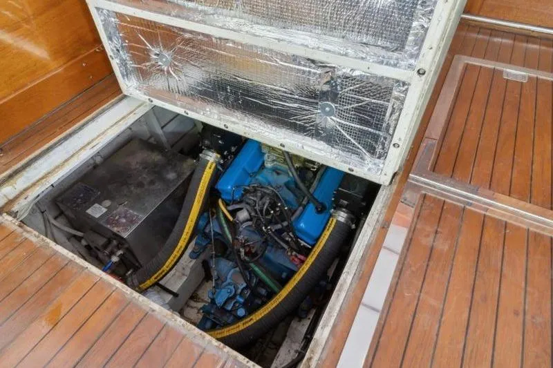 Slide: The Image of Engine compartment of 1964 Chris-Craft 37 Constellation with visible blue engine and wooden flooring. - 28