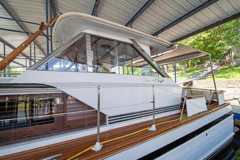 Slide: The Image of 1964 Chris-Craft 37 Constellation yacht under a covered dock, showcasing classic design. - 3
