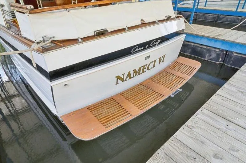 Slide: The Image of 1964 Chris-Craft 37 Constellation boat docked, featuring wooden swim platform. - 34