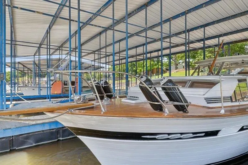 Slide: The Image of 1964 Chris-Craft 37 Constellation docked in a covered marina. - 4