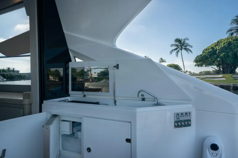 Slide: The Image of Outdoor kitchenette on 2019 Filippetti S55 yacht with sink and storage, surrounded by scenic views. - 13