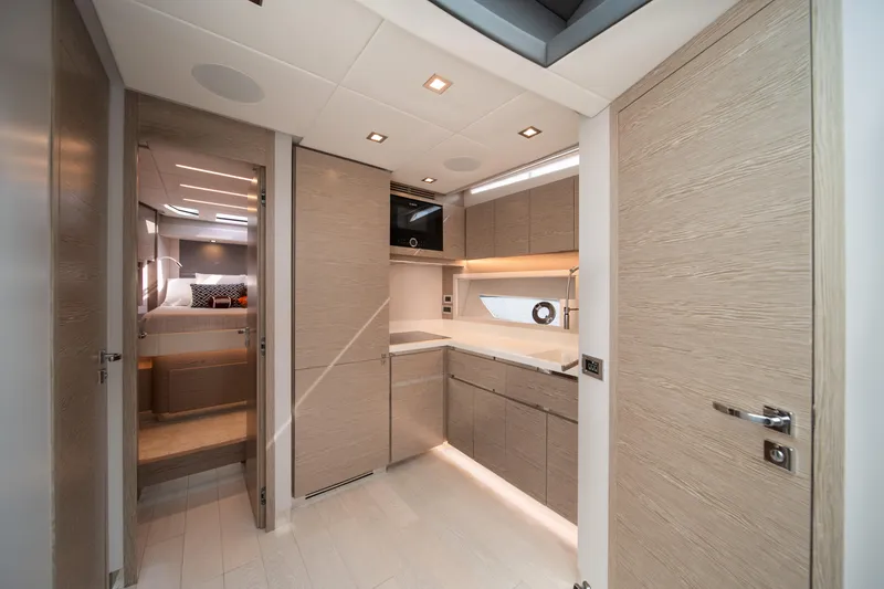 Slide: The Image of Luxurious interior of 2019 Filippetti S55 yacht featuring modern kitchen and cozy bedroom. - 22