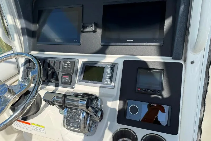 Slide: The Image of Dashboard of 2012 Boston Whaler 250 Outrage with Garmin displays and controls. - 11
