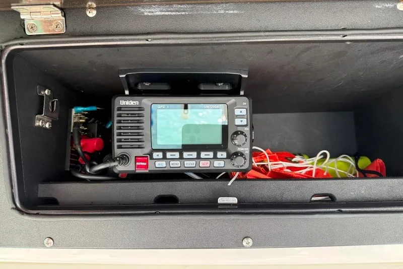 Slide: The Image of Uniden marine radio in 2012 Boston Whaler 250 Outrage storage compartment. - 13