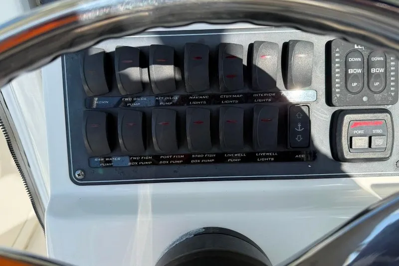 Slide: The Image of Control panel of a 2012 Boston Whaler 250 Outrage boat with various switches. - 15