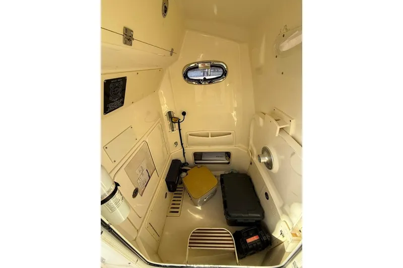 Slide: The Image of Interior cabin of 2012 Boston Whaler 250 Outrage, featuring storage and equipment. - 21