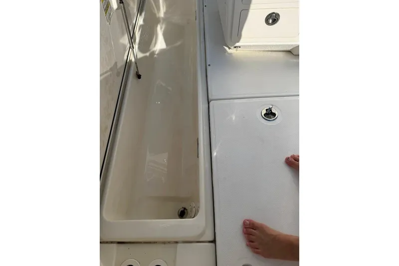 Slide: The Image of 2012 Boston Whaler 250 Outrage deck view with storage compartment and foot. - 27