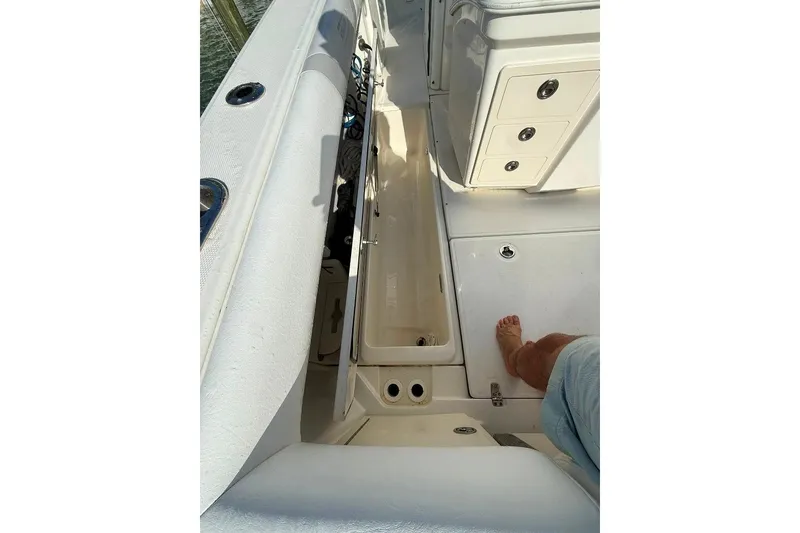 Slide: The Image of 2012 Boston Whaler 250 Outrage boat interior with storage compartments and seating. - 28