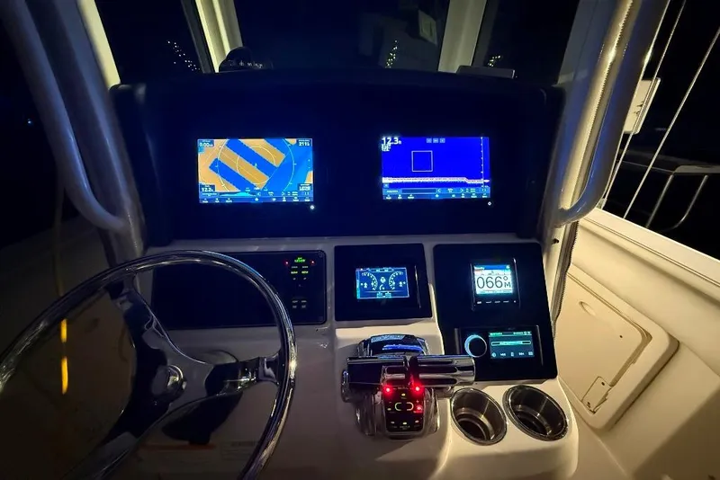 Slide: The Image of Control panel of a 2012 Boston Whaler 250 Outrage boat, illuminated at night. - 30