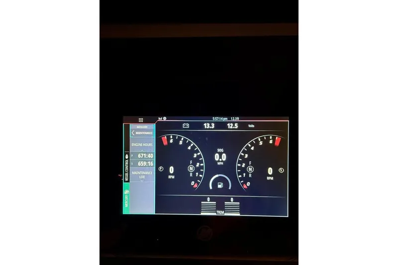 Slide: The Image of Dashboard display of a 2012 Boston Whaler 250 Outrage boat, showing engine metrics. - 31