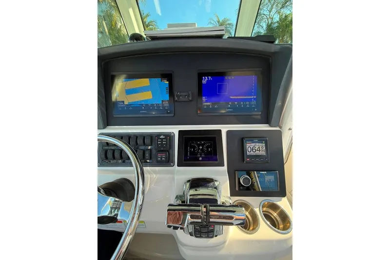 Slide: The Image of Control panel of 2012 Boston Whaler 250 Outrage with navigation screens and controls. - 32