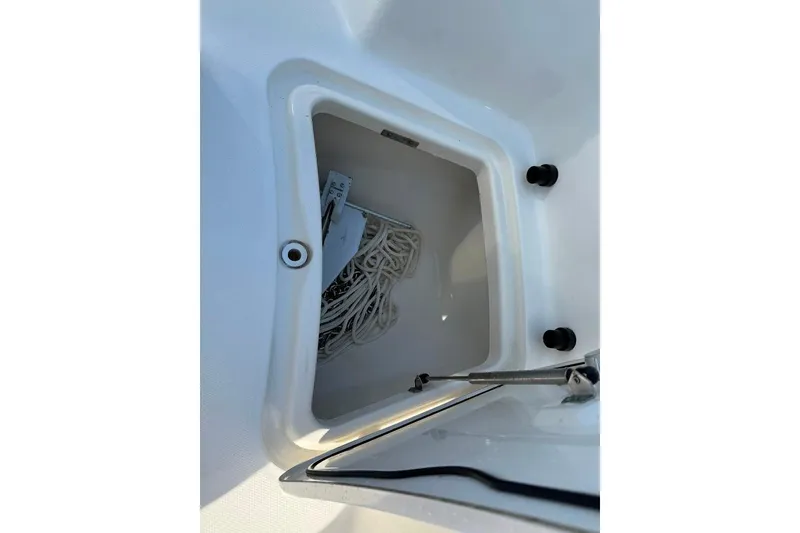 Slide: The Image of Storage compartment on a 2012 Boston Whaler 250 Outrage boat, containing coiled rope. - 5