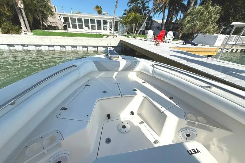 Slide: The Image of 2012 Boston Whaler 250 Outrage boat docked by a waterfront home. - 7