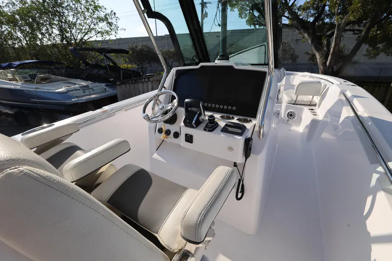 Slide: The Image of 2023 Bertram 28 CC boat cockpit with modern steering and controls. - 12
