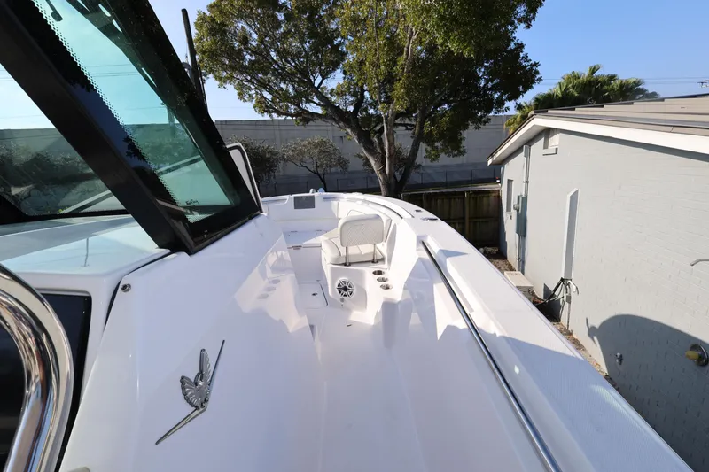 Slide: The Image of 2023 Bertram 28 CC boat deck with seating, windshield, and sleek design. - 16