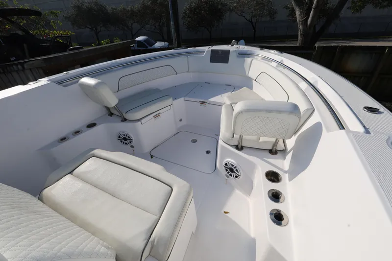 Slide: The Image of 2023 Bertram 28 CC boat interior with white seating and modern design. - 17