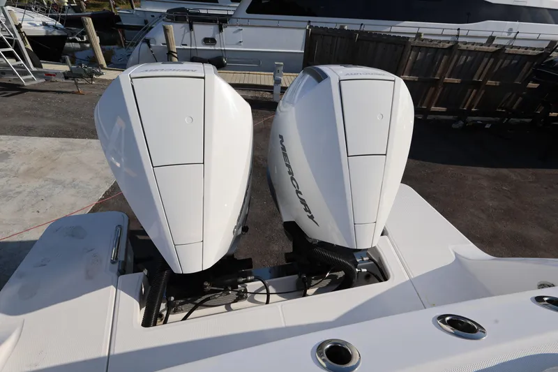 Slide: The Image of 2023 Bertram 28 CC boat with twin Mercury outboard engines at a marina. - 22