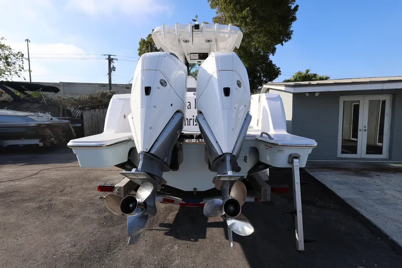 Slide: The Image of 2023 Bertram 28 CC boat with dual outboard engines, rear view. - 4