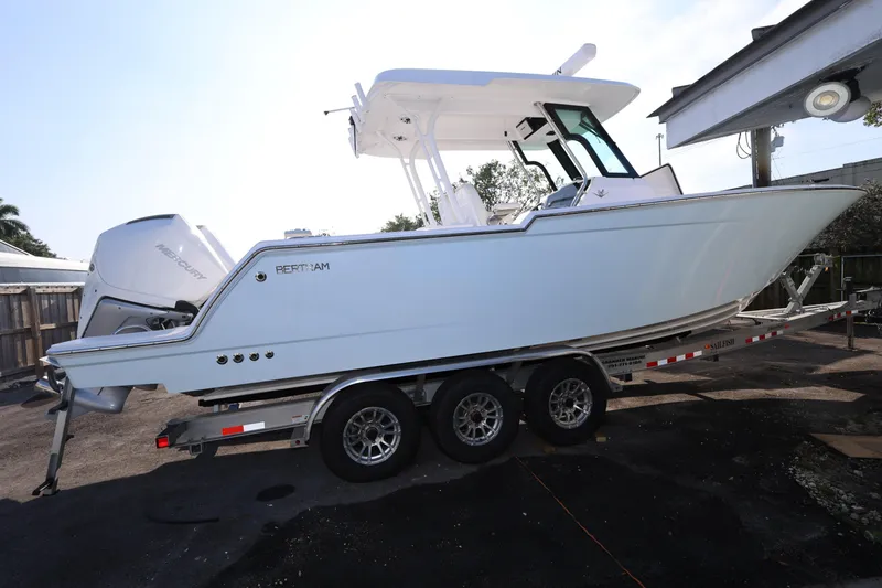 Slide: The Image of 2023 Bertram 28 CC boat on trailer, side view, with Mercury engine. - 6