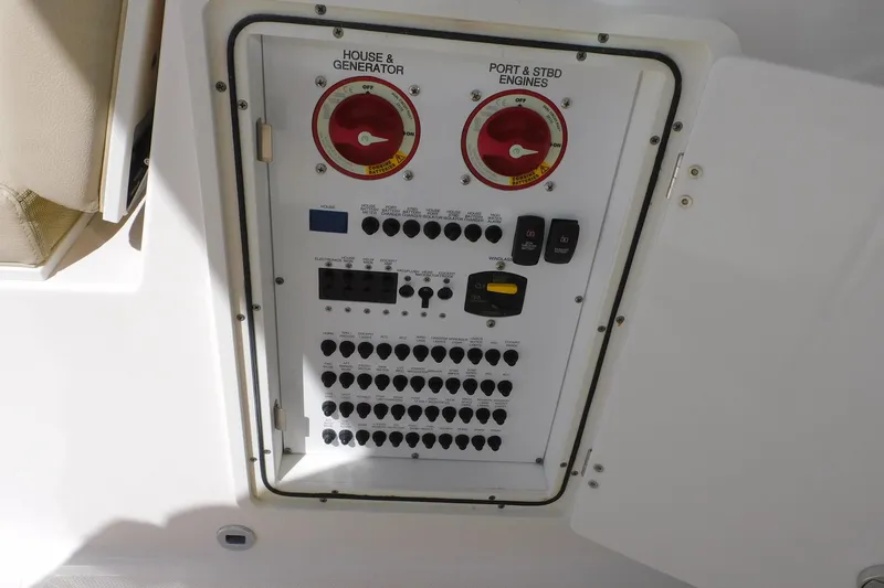 Slide: The Image of Electrical panel of 2016 Pursuit DC 325 Dual Console boat, featuring switches and controls. - 26