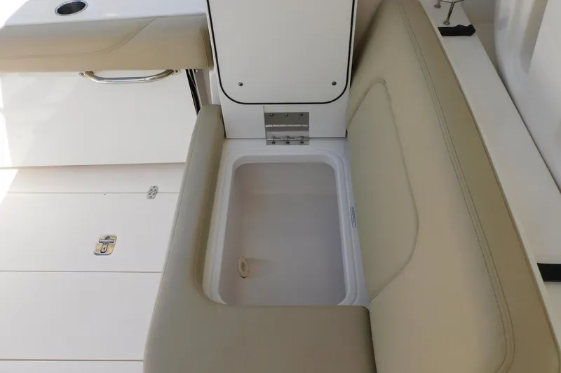 Slide: The Image of 2016 Pursuit DC 325 Dual Console boat seat with integrated storage compartment. - 30