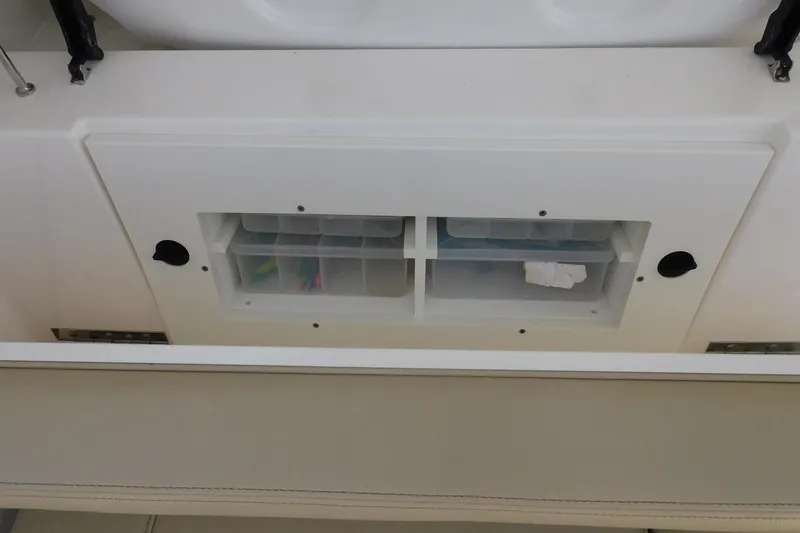 Slide: The Image of Storage compartment on a 2016 Pursuit DC 325 Dual Console boat. - 31