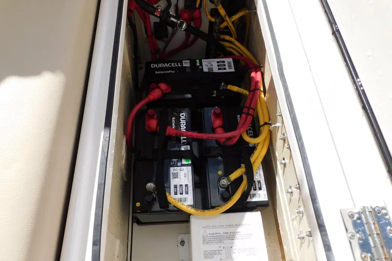 Slide: The Image of Battery compartment of 2016 Pursuit DC 325 Dual Console with Duracell batteries and wiring. - 35