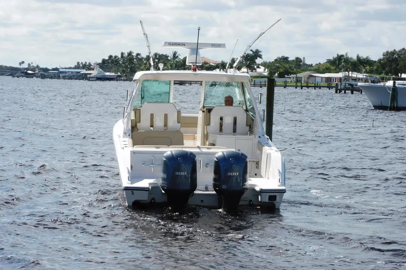 Slide: The Image of 2016 Pursuit DC 325 Dual Console boat on water with twin Yamaha engines. - 39