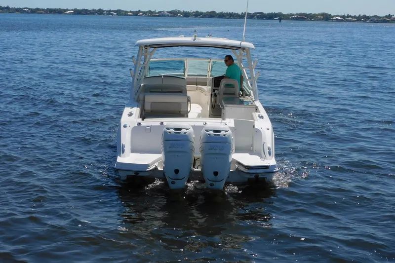 Slide: The Image of 2016 Pursuit DC 325 Dual Console boat on open water, rear view. - 4