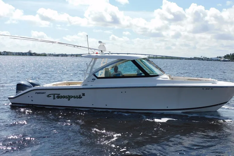 Slide: The Image of 2016 Pursuit DC 325 Dual Console boat cruising on a sunny day. - 41