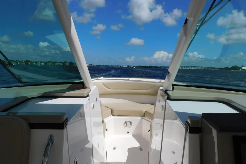 Slide: The Image of 2016 Pursuit DC 325 Dual Console boat interior with ocean view and blue sky. - 6