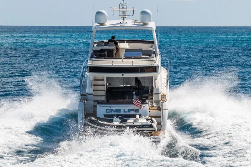Slide: The Image of 2016 Princess 60 Flybridge Motor Yacht cruising on open sea, rear view. - 14