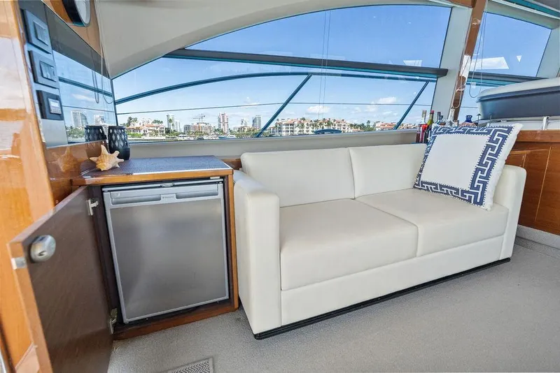 Slide: The Image of Luxurious interior of 2016 Princess 60 Flybridge Yacht with sofa and mini fridge. - 18