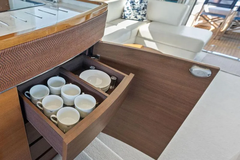Slide: The Image of Open cabinet with cups and plates on 2016 Princess 60 Flybridge Motor Yacht. - 23